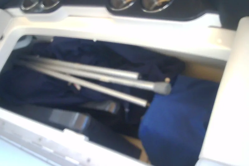 Slide: The Image of Storage compartment in a 2020 Formula 350 Crossover Bowrider with metal poles and fabric. - 67