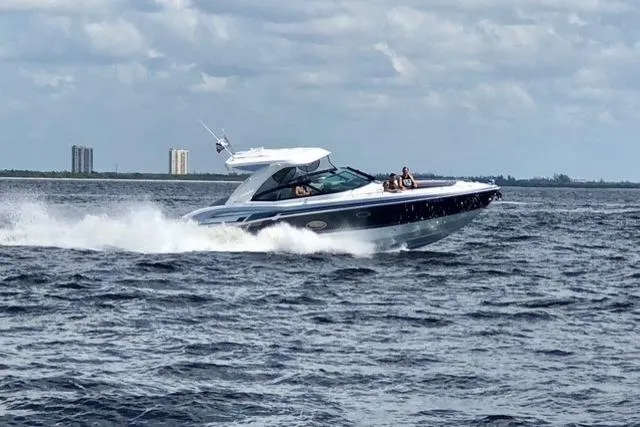 Slide: The Image of 2020 Formula 350 Crossover Bowrider cruising on open water under cloudy skies. - 74