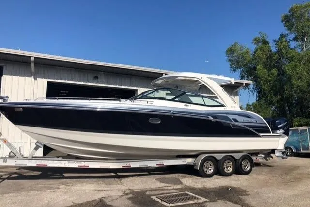 Slide: The Image of 2020 Formula 350 Crossover Bowrider on trailer, parked outdoors near a building. - 77