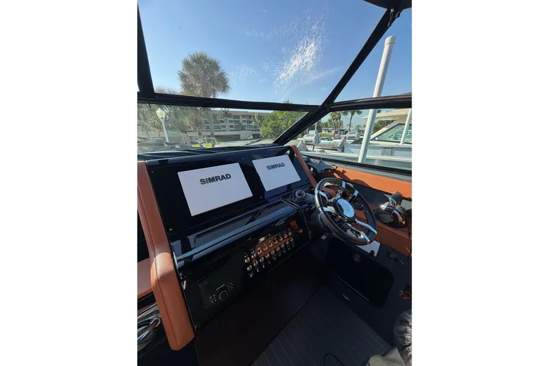 Slide: The Image of 2022 Cruisers Yachts 38 GLS OB helm with Simrad displays and modern steering wheel. - 11