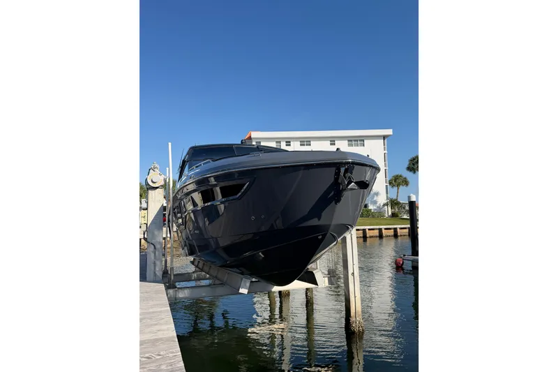 Slide: The Image of 2022 Cruisers Yachts 38 GLS OB docked, showcasing sleek design against clear blue sky. - 5