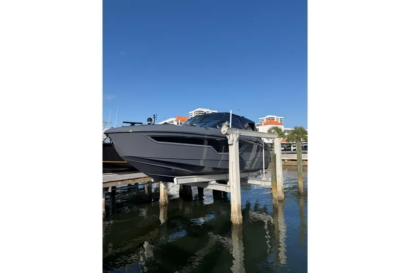 Slide: The Image of 2022 Cruisers Yachts 38 GLS OB on lift, docked by waterfront. - 6