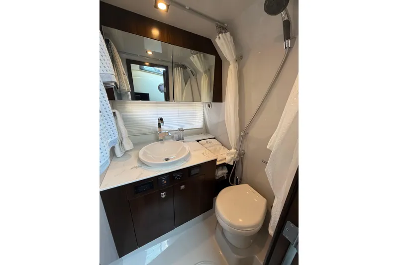 Slide: The Image of Luxurious bathroom in 2022 Cruisers Yachts 38 GLS OB with modern fixtures and elegant design. - 7