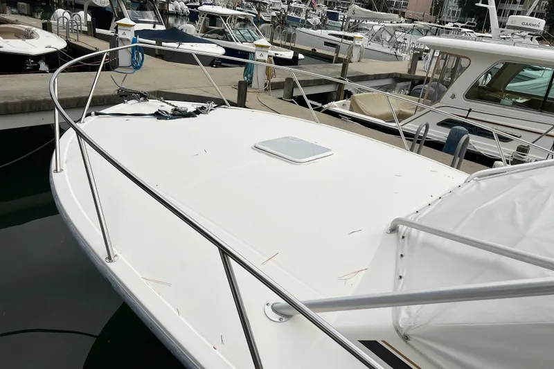 Slide: The Image of 2005 Carolina Classic 35 boat docked at marina, featuring spacious deck and railing. - 3