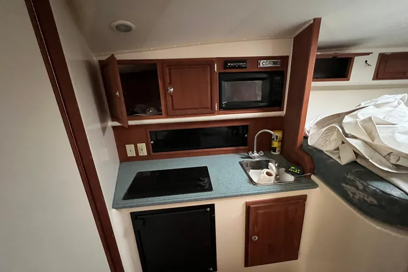 Slide: The Image of 2005 Carolina Classic 35 boat interior kitchen with microwave, sink, and storage cabinets. - 9