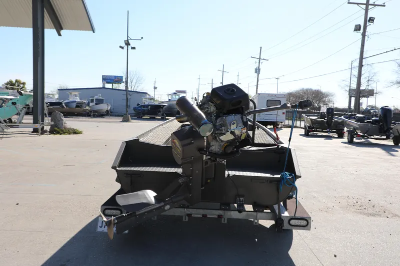 Slide: The Image of 2021 Gator Trax 1654 boat with motor on trailer in outdoor dealership lot. - 2
