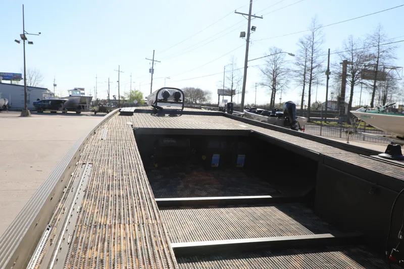 Slide: The Image of 2021 Gator Trax 1654 boat with open deck, parked outdoors under clear sky. - 6