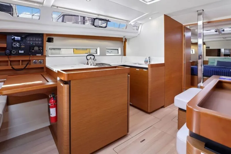 Slide: The Image of Interior of 2018 Jeanneau Sun Odyssey 440 yacht, featuring modern kitchen and seating area. - 10