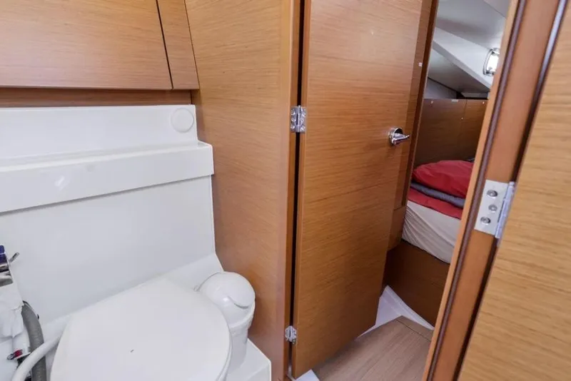 Slide: The Image of Interior of 2018 Jeanneau Sun Odyssey 440 yacht, featuring bathroom and cabin entrance. - 12