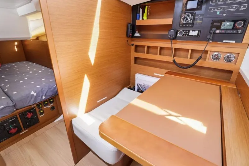 Slide: The Image of Interior of 2018 Jeanneau Sun Odyssey 440 sailboat with navigation station and cozy cabin. - 14