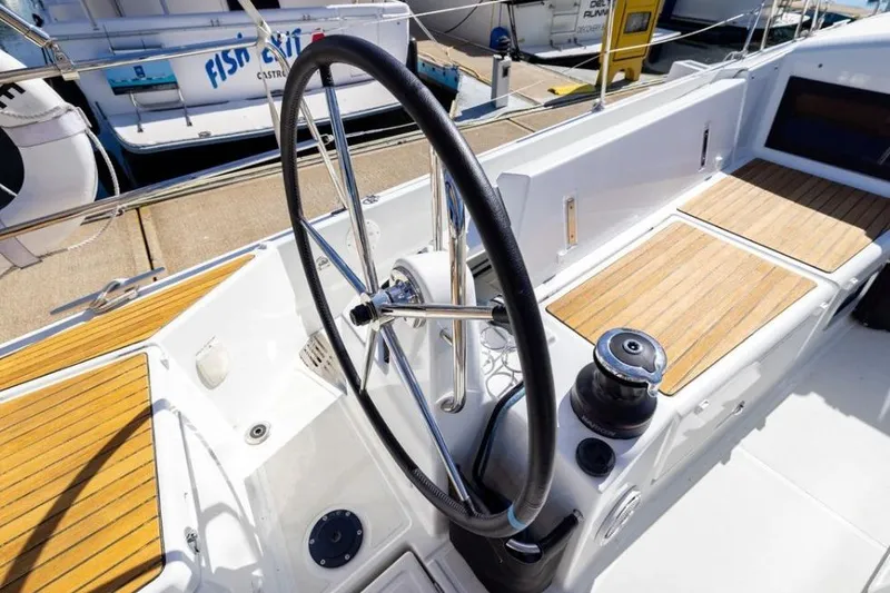 Slide: The Image of Cockpit of 2018 Jeanneau Sun Odyssey 440 sailboat with steering wheel and teak seating. - 16