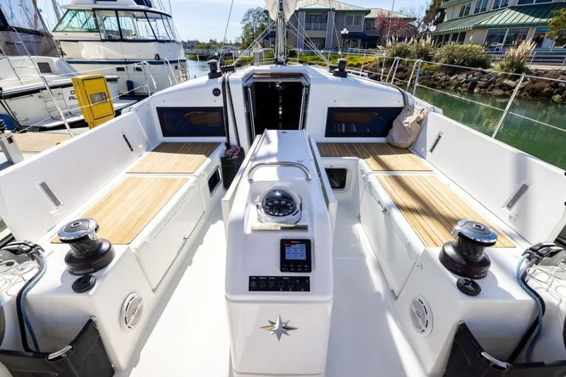 Slide: The Image of Cockpit of 2018 Jeanneau Sun Odyssey 440 sailboat with teak seating and navigation equipment. - 17