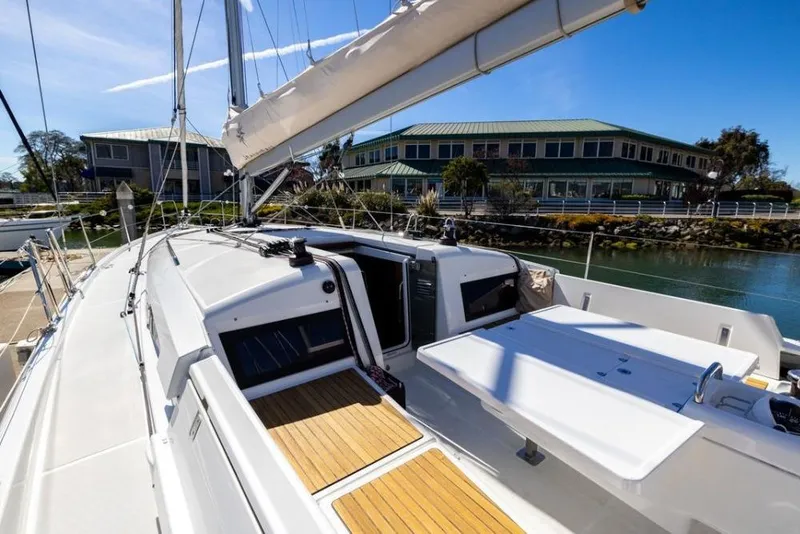 Slide: The Image of 2018 Jeanneau Sun Odyssey 440 sailboat docked, showcasing sleek deck design and modern architecture. - 20