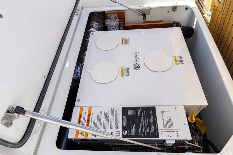 Slide: The Image of Engine compartment of a 2018 Jeanneau Sun Odyssey 440 sailboat, showcasing mechanical components. - 21