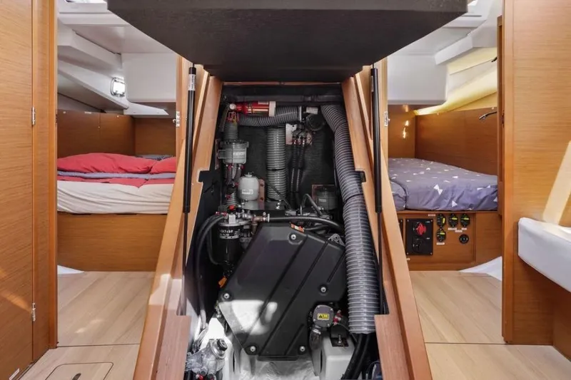 Slide: The Image of Engine compartment of 2018 Jeanneau Sun Odyssey 440 yacht, with visible cabins and wooden interior. - 23