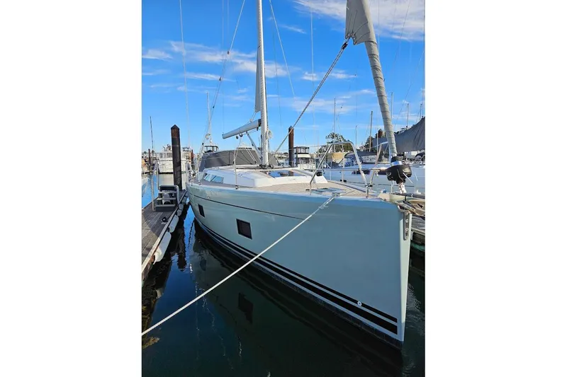 Slide: The Image of 2018 Jeanneau Sun Odyssey 440 sailboat docked at marina under clear blue sky. - 27