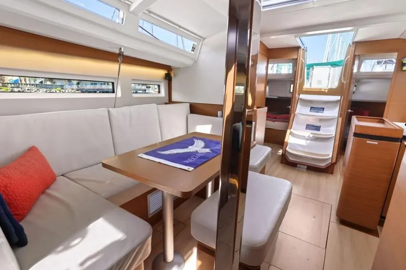 Slide: The Image of Interior of 2018 Jeanneau Sun Odyssey 440 yacht, featuring modern seating and dining area. - 8