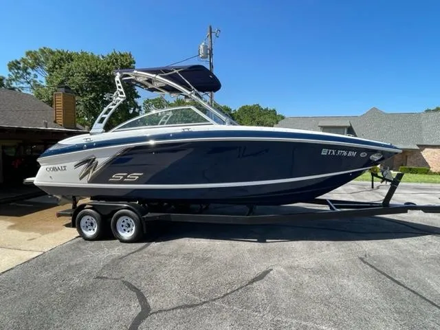 The Image of 2011 Cobalt 242 WSS boat docked in a marina, featuring sleek design and modern amenities. - 0