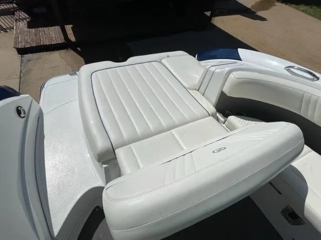Slide: The Image of Luxurious white seating in 2011 Cobalt 242 WSS boat, featuring elegant design and wood flooring. - 12