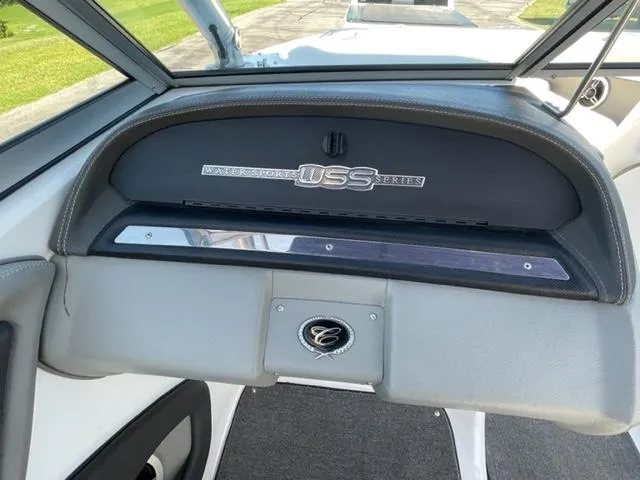 Slide: The Image of 2011 Cobalt 242 WSS boat with white leather seating and teak flooring by the water. - 16