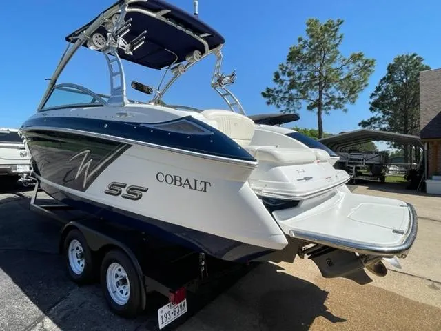 Slide: The Image of 2011 Cobalt 242 WSS boat docked in a covered marina. - 2