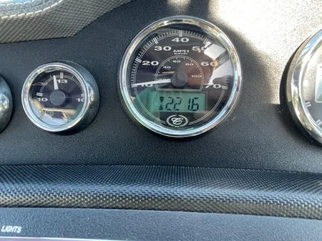 Slide: The Image of 2011 Cobalt 242 WSS boat docked with blue cover in marina. - 20