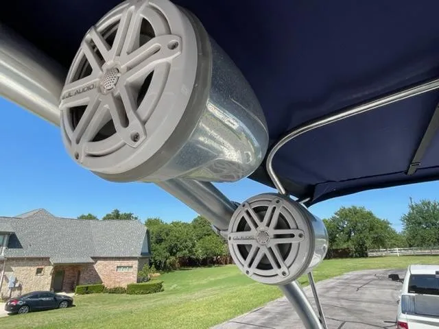 Slide: The Image of 2011 Cobalt 242 WSS boat docked in marina with storage cabinets nearby. - 21