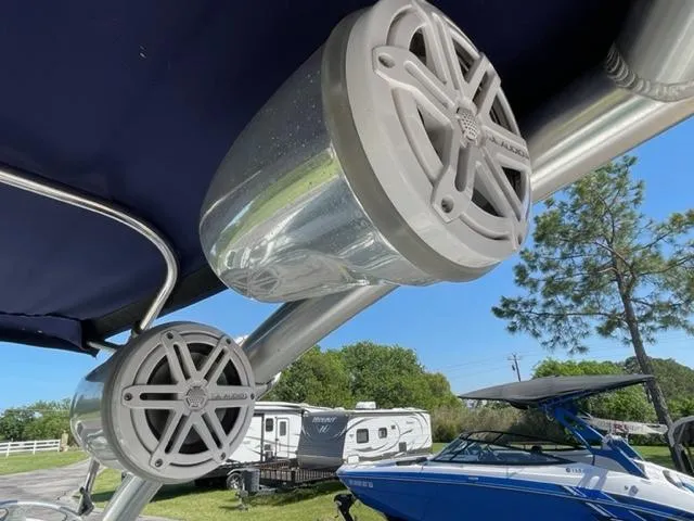 Slide: The Image of 2011 Cobalt 242 WSS boat parked on trailer outdoors. - 22