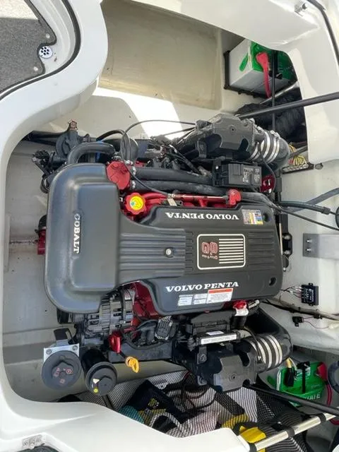 Slide: The Image of 2011 Cobalt 242 WSS boat parked on trailer outdoors. - 23