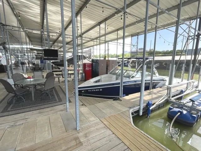 Slide: The Image of Trailer for 2011 Cobalt 242 WSS boat parked on suburban street. - 33