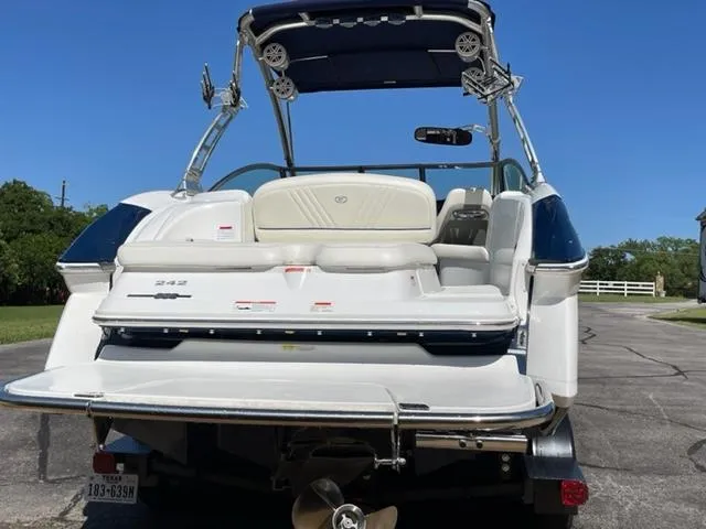 Slide: The Image of 2011 Cobalt 242 WSS boat interior with white seating and wood flooring. - 4