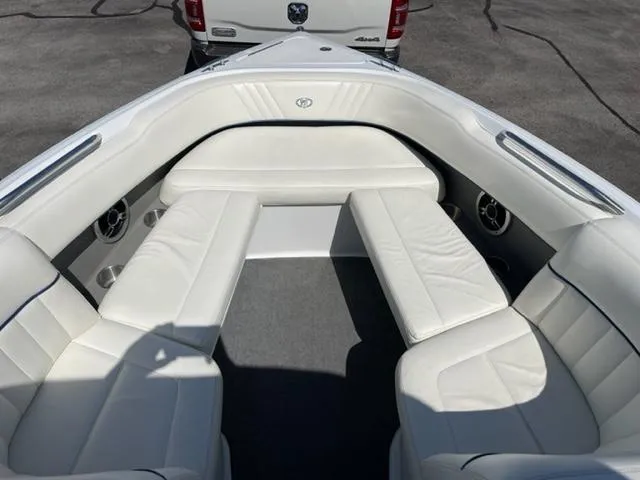 Slide: The Image of 2011 Cobalt 242 WSS boat interior with white seating and wood-style flooring. - 7
