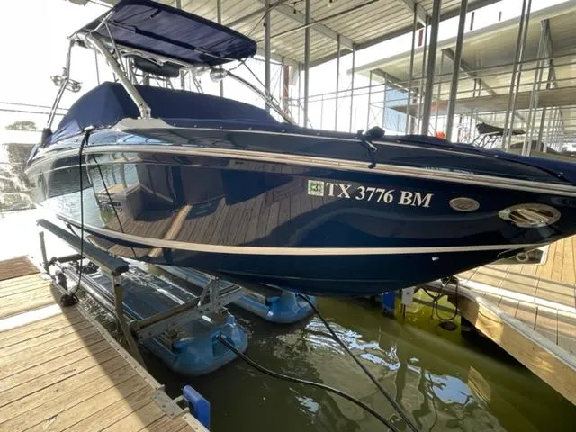 Slide: The Image of Interior of a 2011 Cobalt 242 WSS boat with white seating and wood flooring. - 8