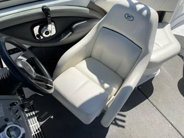 Slide: The Image of Interior of a 2011 Cobalt 242 WSS boat with white seating and wood flooring. - 9