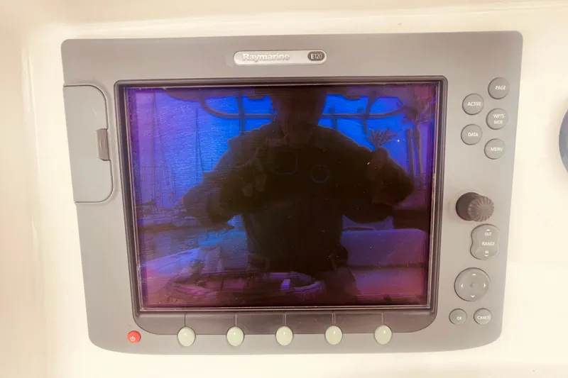 Slide: The Image of Raymarine E120 display on 2006 Boston Whaler 320 Outrage boat dashboard. - 12