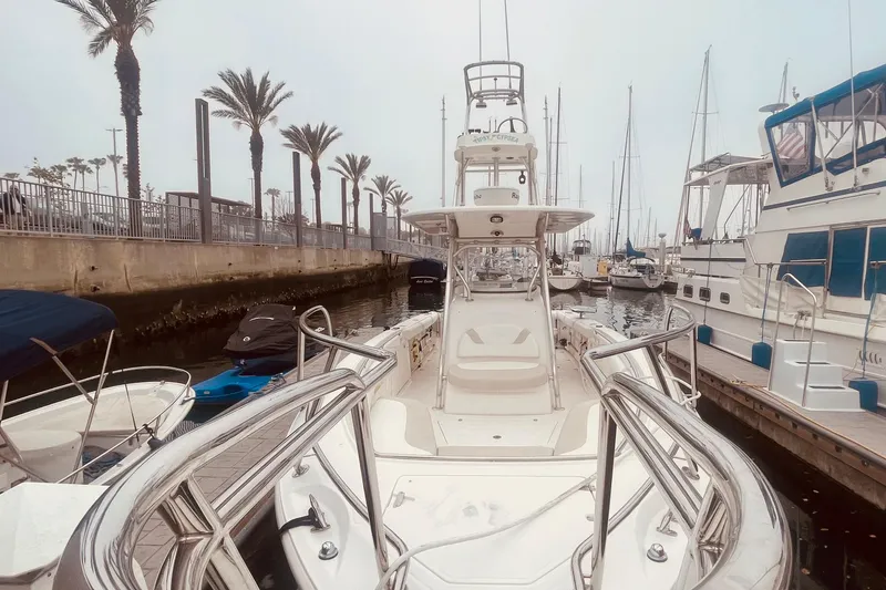 Slide: The Image of 2006 Boston Whaler 320 Outrage docked, surrounded by palm trees and waterfront. - 4