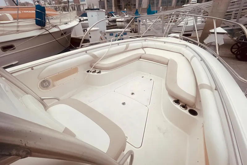 Slide: The Image of 2006 Boston Whaler 320 Outrage boat docked, featuring spacious seating and dual engines. - 6