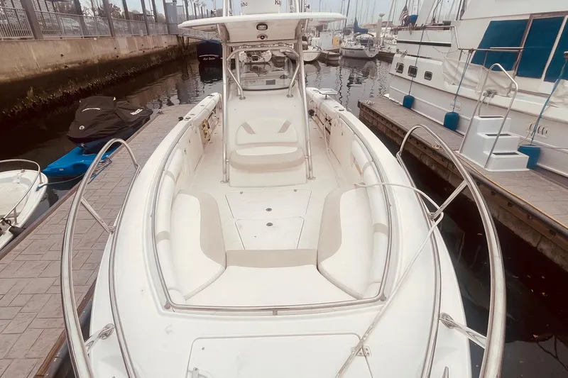 Slide: The Image of 2006 Boston Whaler 320 Outrage docked in a marina with palm trees. - 8