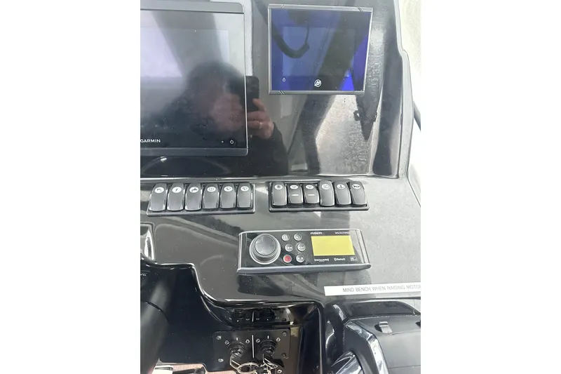 Slide: The Image of 2023 Beneteau Antares 9 dashboard with Garmin display and control panel. - 10