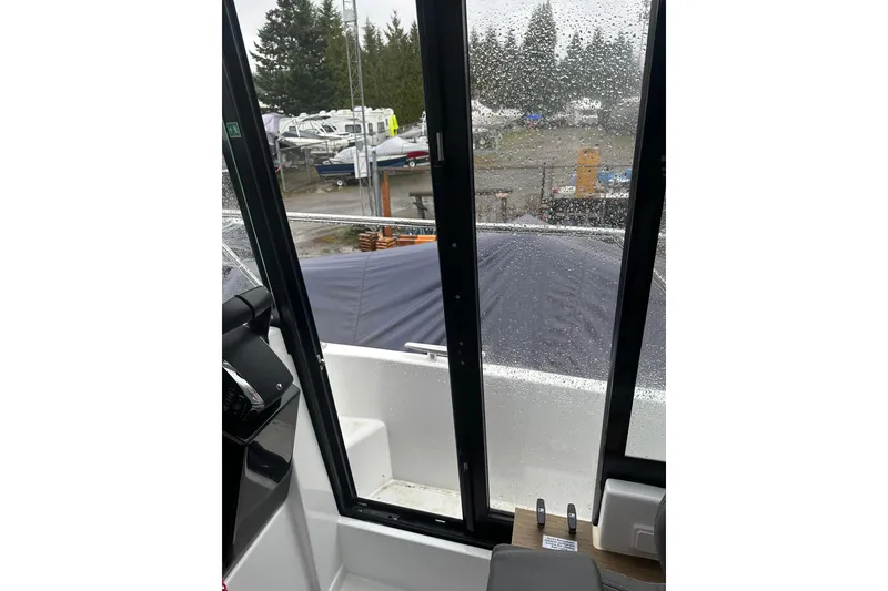 Slide: The Image of Interior view of 2023 Beneteau Antares 9 boat with rain on windows. - 12