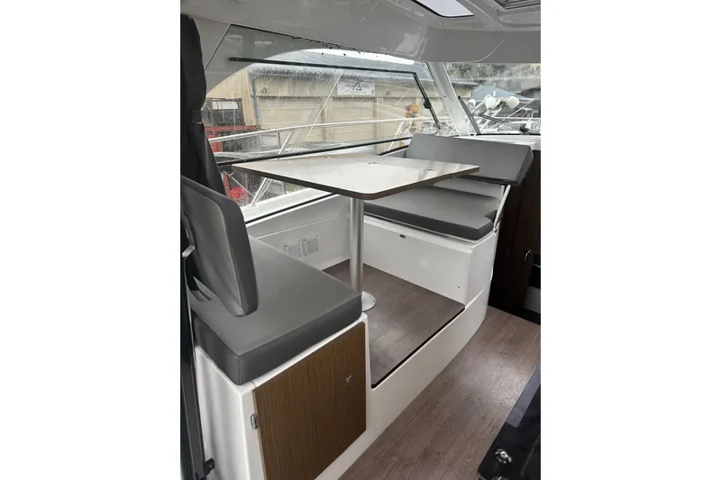 Slide: The Image of Interior of 2023 Beneteau Antares 9 with modern seating and table setup. - 19