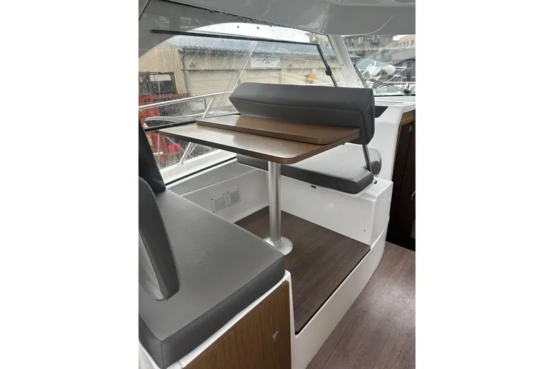 Slide: The Image of Interior of 2023 Beneteau Antares 9 boat with seating and table. - 22