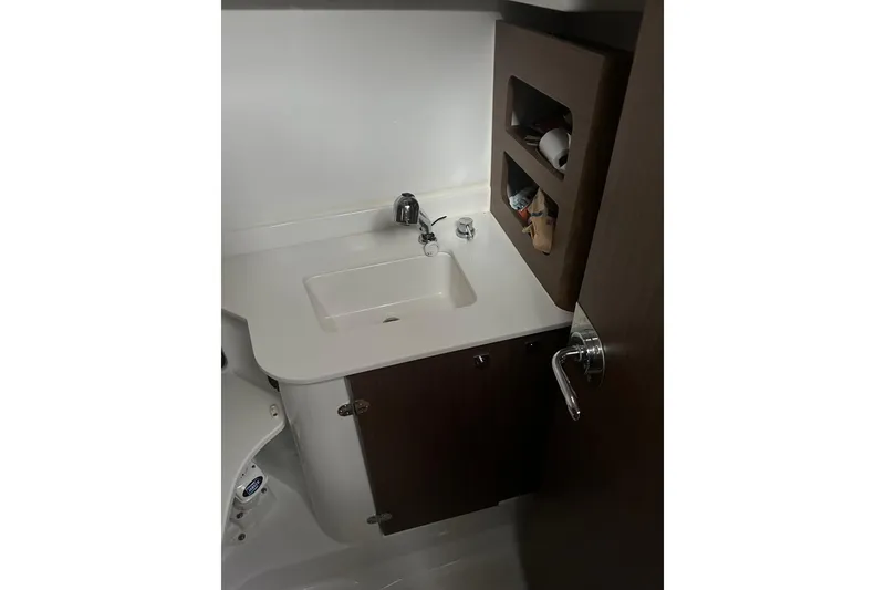 Slide: The Image of 2023 Beneteau Antares 9 bathroom with sink and storage shelves. - 25