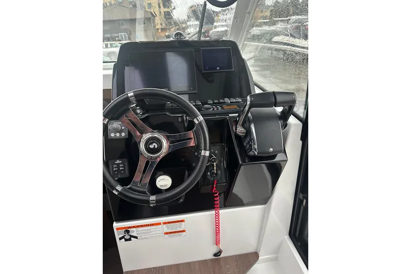 Slide: The Image of Helm of 2023 Beneteau Antares 9 with modern controls and steering wheel. - 5