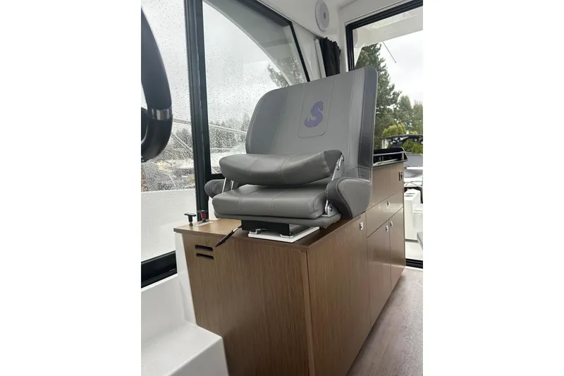 Slide: The Image of Captain's chair in 2023 Beneteau Antares 9 boat interior, featuring sleek design and comfort. - 6
