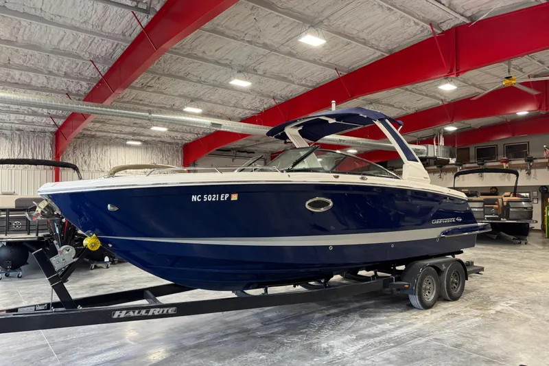 The Image of 2020 Chaparral 287 SSX boat on trailer in indoor storage facility. - 1