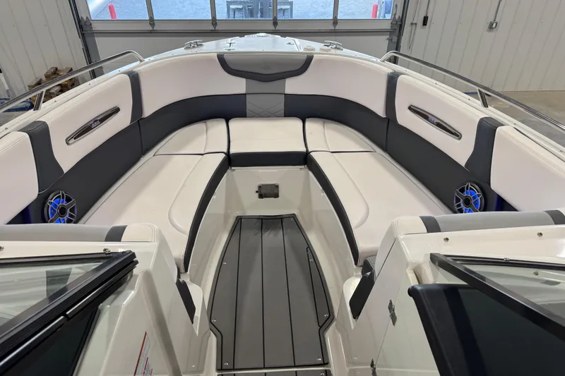 Slide: The Image of 2020 Chaparral 287 SSX boat interior with white and gray seating in a garage. - 11
