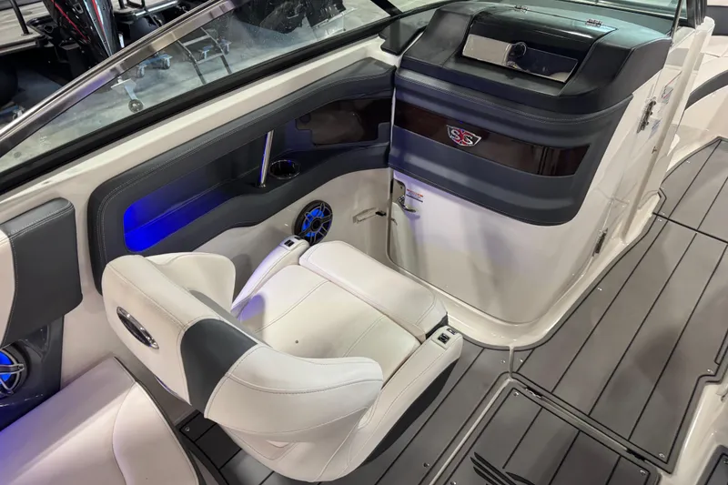 Slide: The Image of 2020 Chaparral 287 SSX boat interior with white seating and modern dashboard. - 12