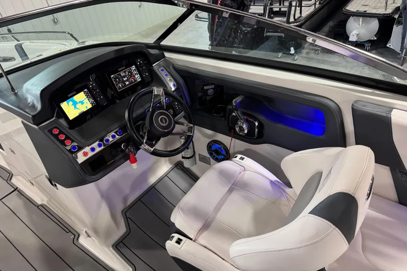 Slide: The Image of 2020 Chaparral 287 SSX boat cockpit with modern controls and navigation displays. - 13