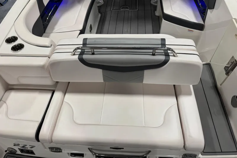 Slide: The Image of 2020 Chaparral 287 SSX boat interior with white seating and cup holders. - 6